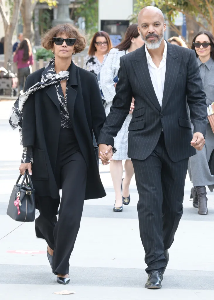 Halle Berry and Van Hunt holding hands outside a courthouse.