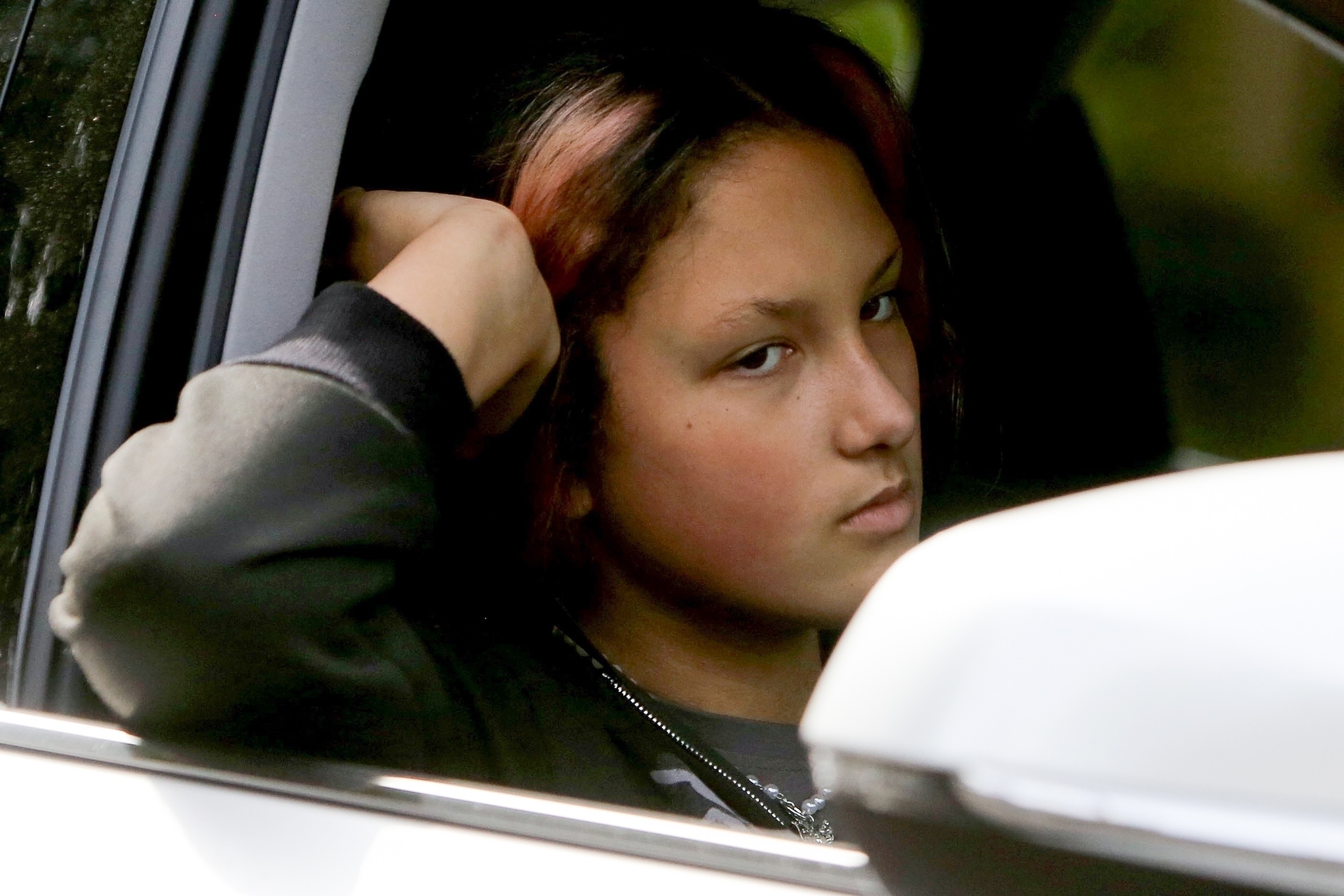 Nahla Ariela Aubry looks bored while riding in the passenger seat of a car.