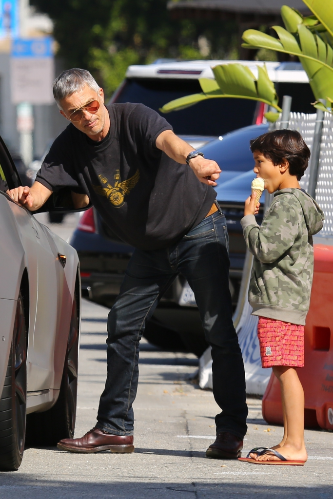 Olivier Martinez, in a black T-shirt and blue jeans, with his Maceo Robert Martinez, in a khaki hooded sweatshirt and red shorts.