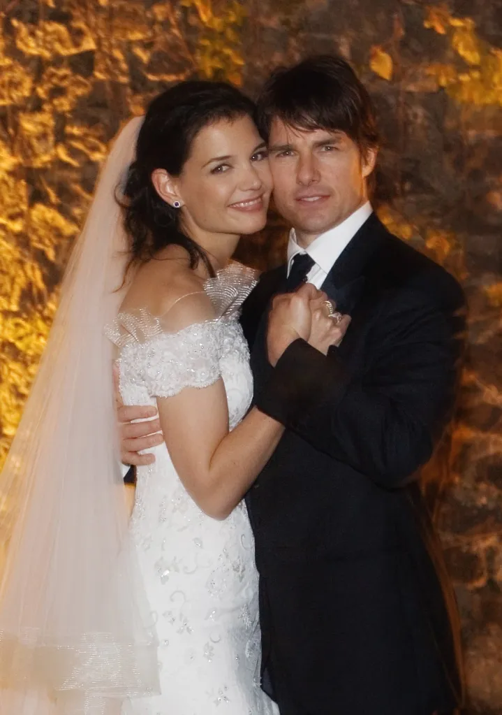 Tom Cruise and Katie Holmes embracing on their wedding day.