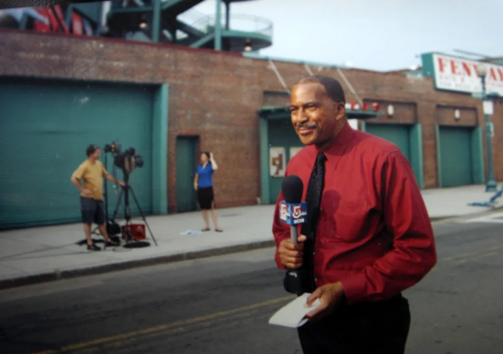 Former WCVB reporter Jim Boyd at work at Fenway Park, holding a microphone.