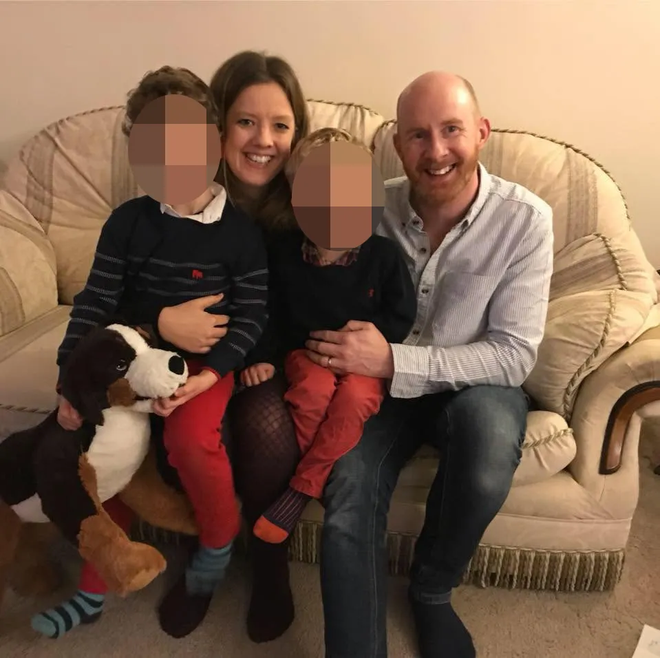 Hannah Terry with her husband Mark Cain and their two children on a couch.