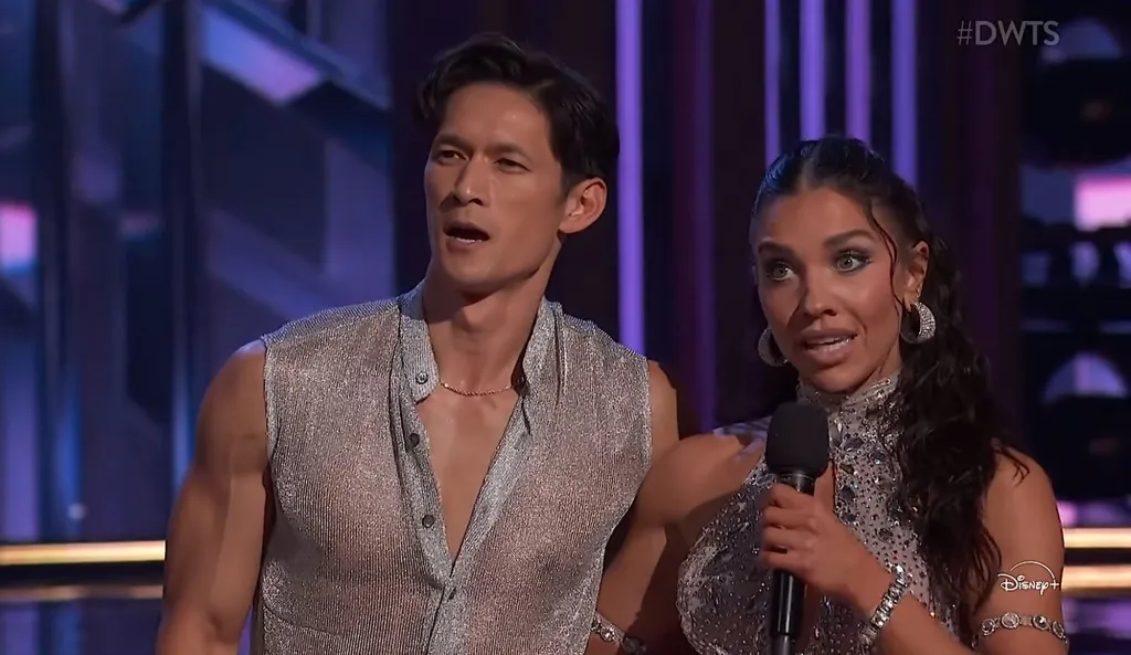 Harry Shum Jr. and Jenna Johnson standing on stage with a microphone.