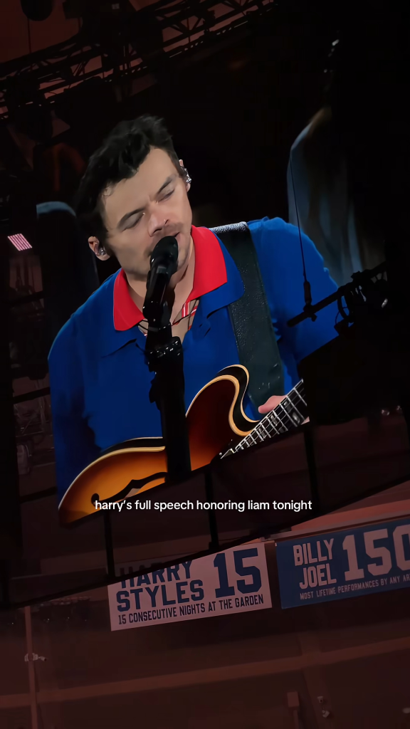 Harry Styles performing with a guitar on stage in front of a banner celebrating 15 consecutive nights at Madison Square Garden.