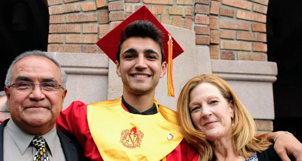 Jolayne Houtz and her son Sam Martinez in a graduation cap and gown with a man.
