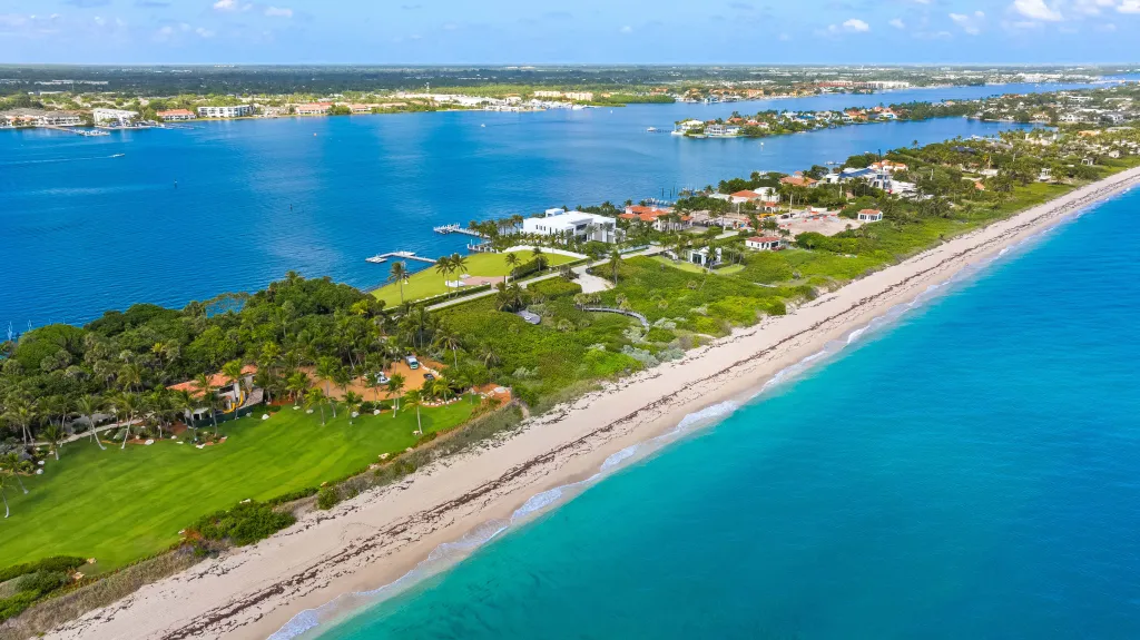 The four-acre Manalapan waterfront property was split between billionaire neighbors Larry Ellison and David MacNeil in deals totaling $67 million.
