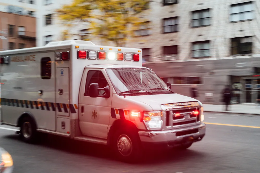 A high-speed ambulance travels on a New York City street.