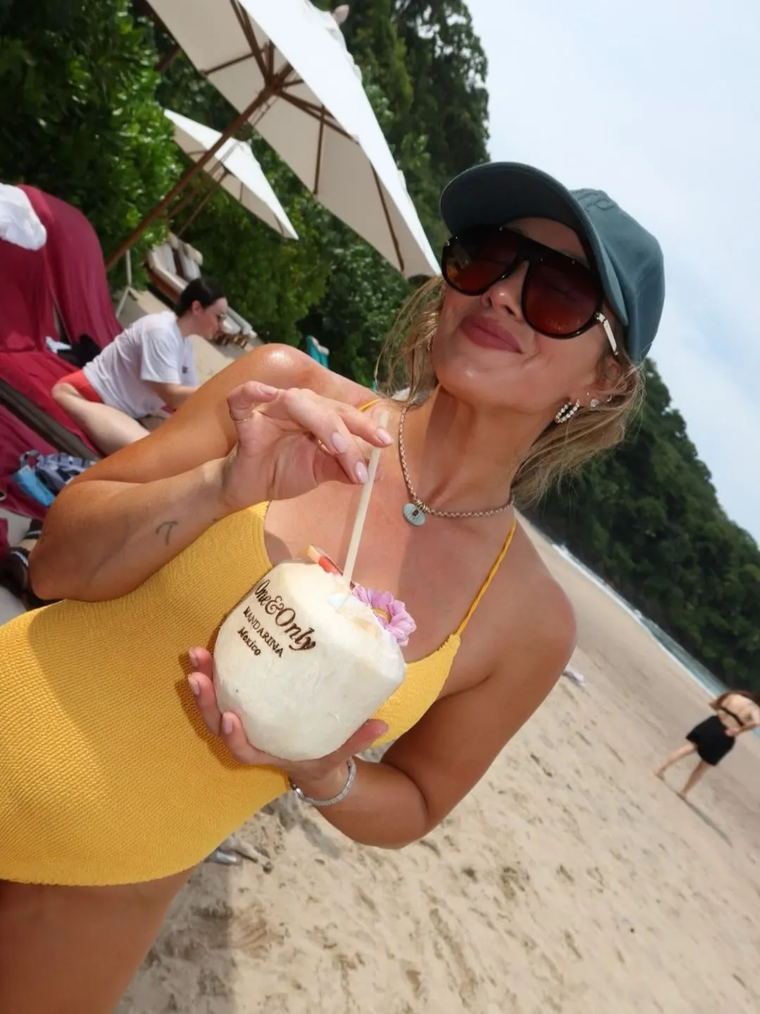 Hilary Duff posed in a bright yellow swimsuit while holding a coconut during a girls' getaway to Mexico. 