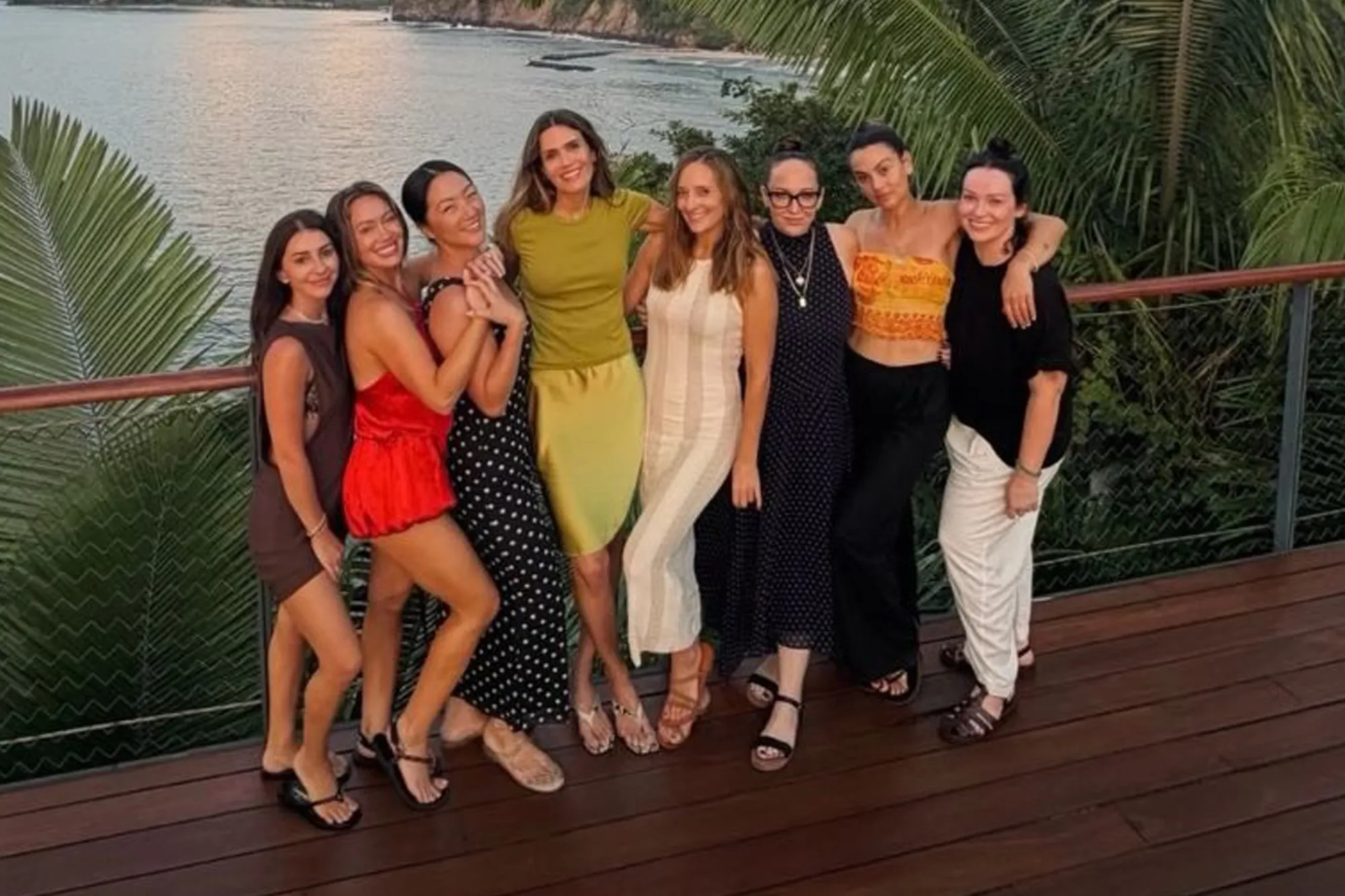 Duff also shared a group photo of eight women posing together on a wooden terrace overlooking the ocean at sunset with palm trees framing the backdrop.