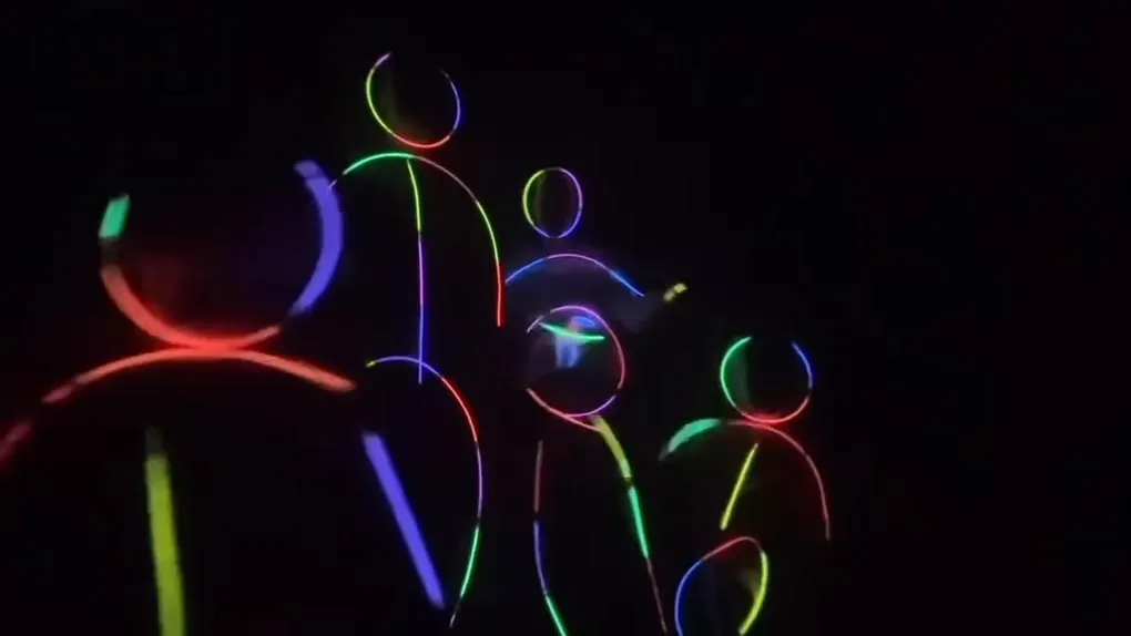 Four stick figures outlined in glowing neon lights against a dark background, with the third figure from the left showing a glowing green baby bump.