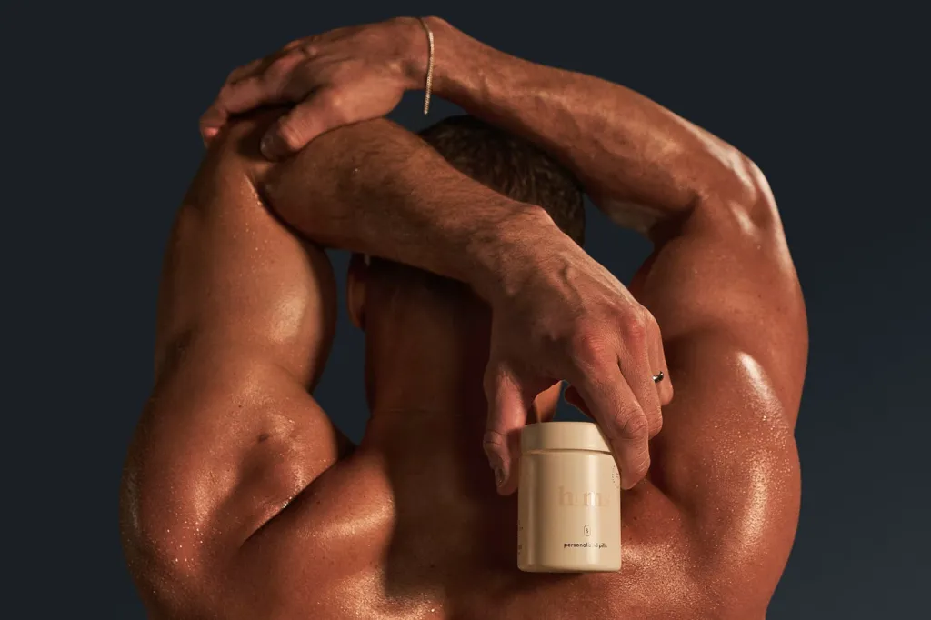 photo of a man holding a pill bottle from hims