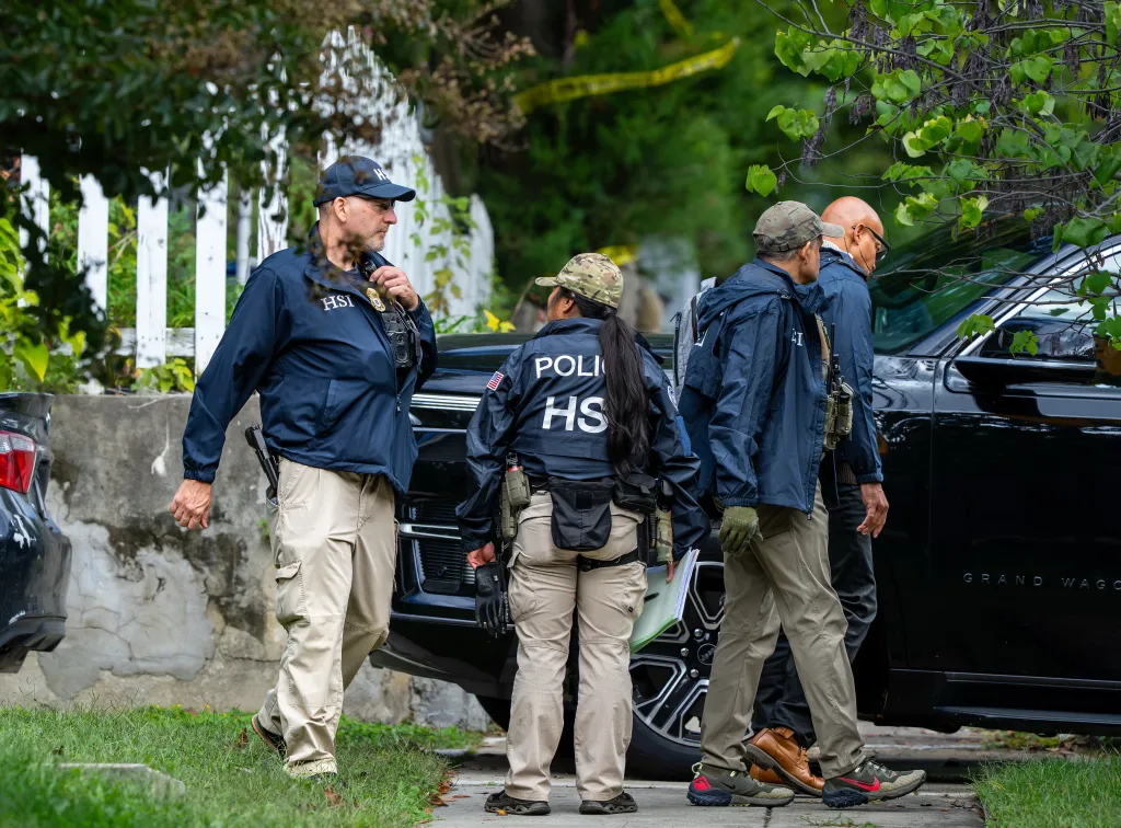 Homeland Security officers leave the Washington residence of Rep. Ilhan Omar after a search.