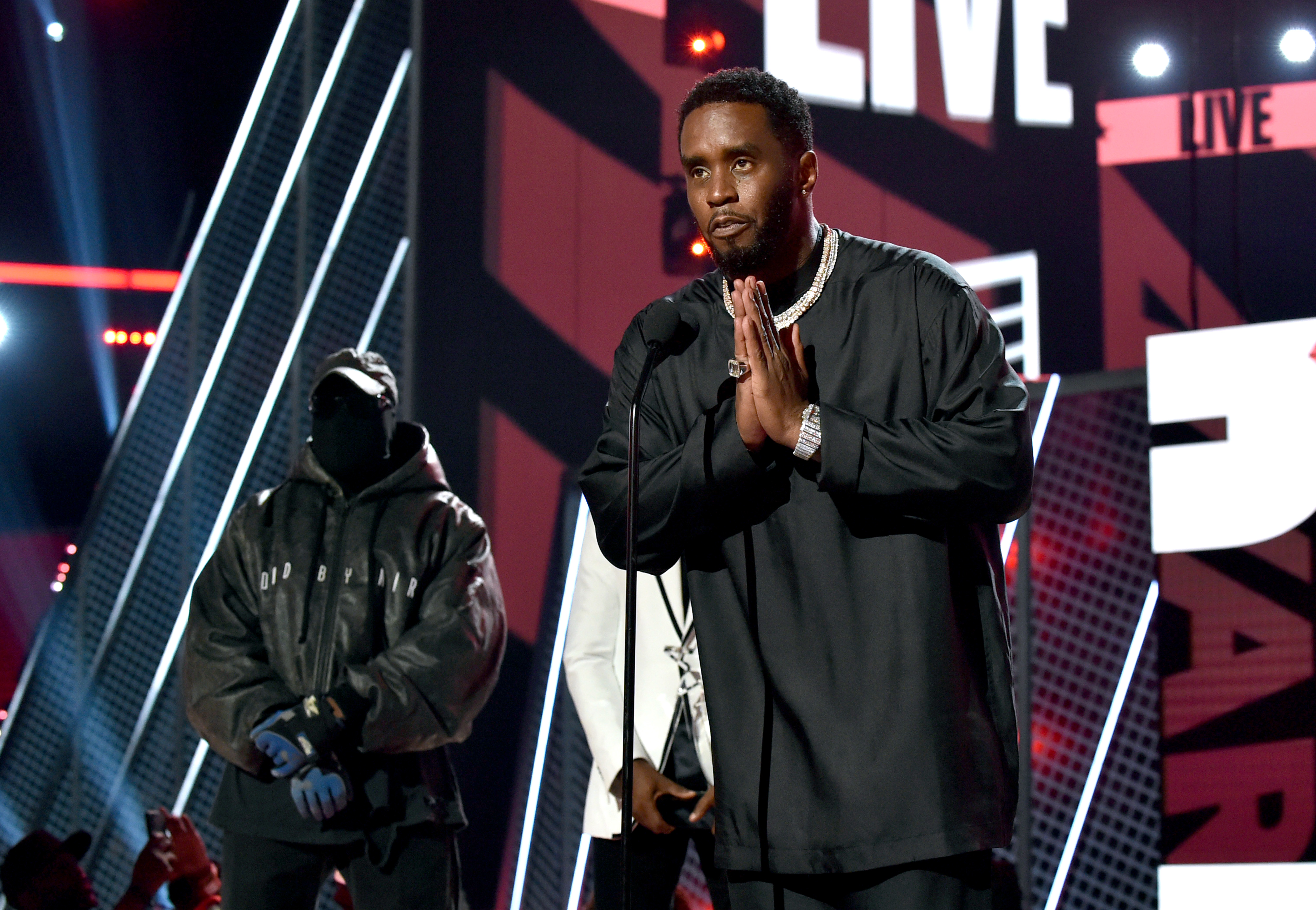 Sean 'Diddy' Combs accepts the Lifetime Achievement Award onstage at the BET Awards, as Kanye West stands behind him.