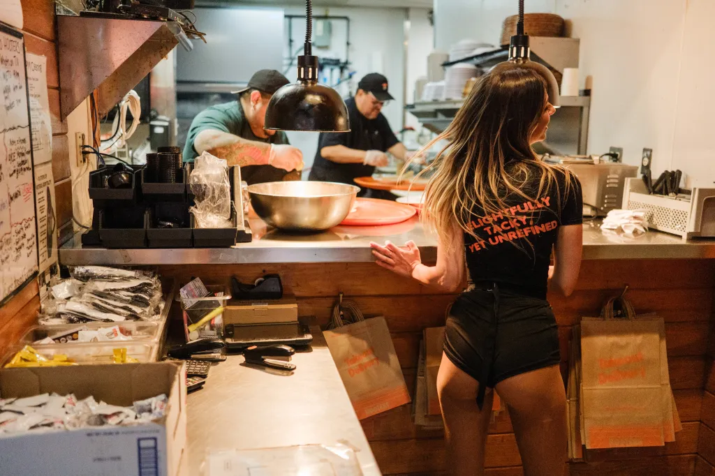 Hooters server Lana Greenberg in the kitchen of the Fresh Meadows location.