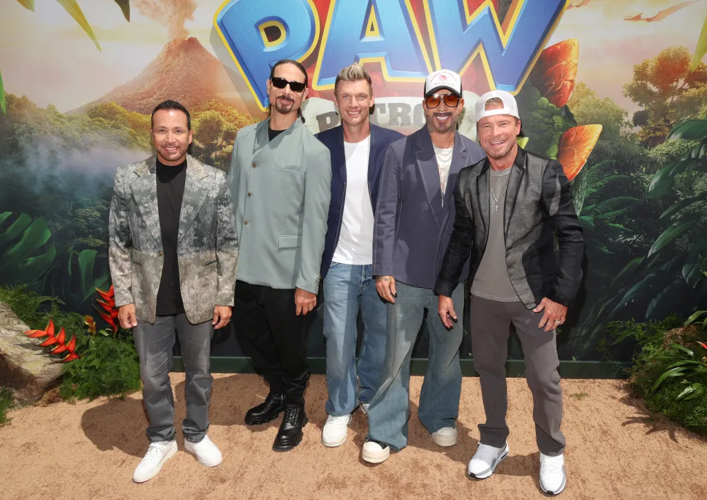 Members of the Backstreet Boys, including Howie Dorough, Kevin Richardson, Nick Carter, AJ McLean and Brian Littrell, pose together at a movie premiere.