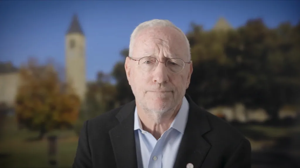 President Michael I. Kotlikoff in front of a blurred background of the Cornell campus.