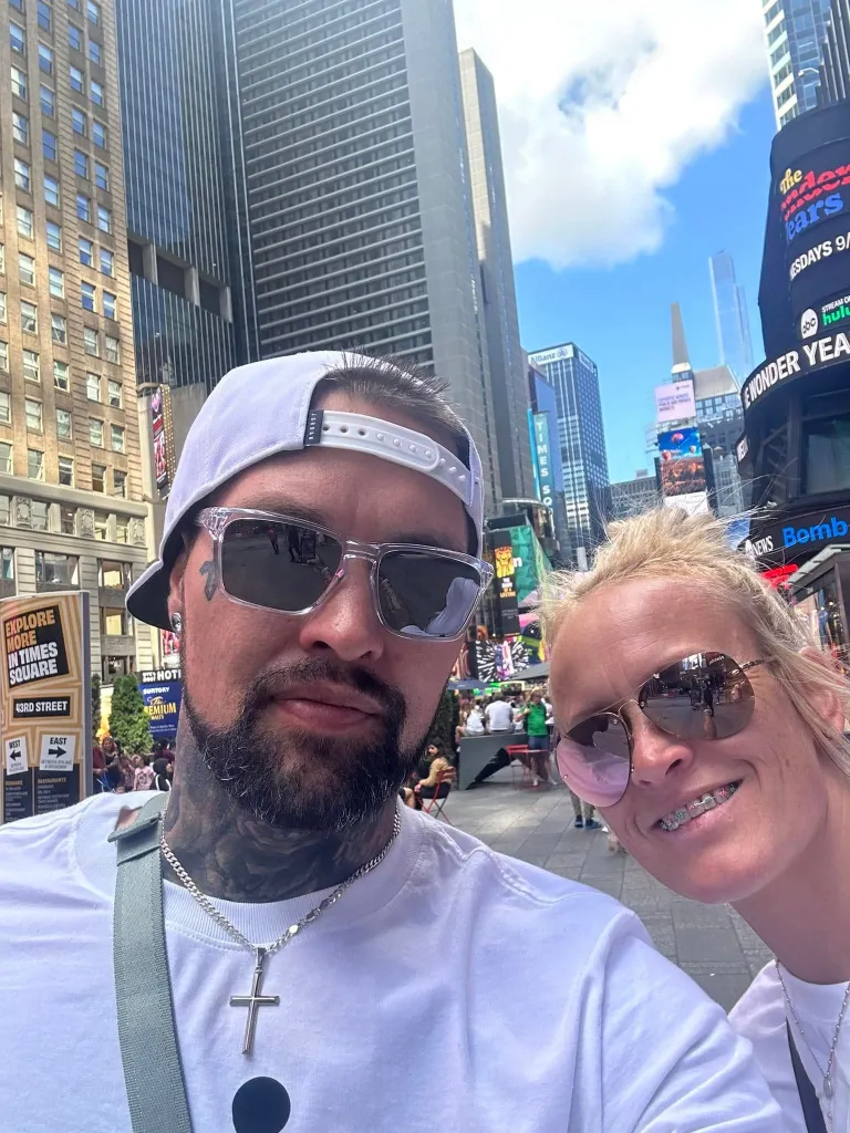 Cody and Honey Phipps posing for a selfie in Times Square, New York City.