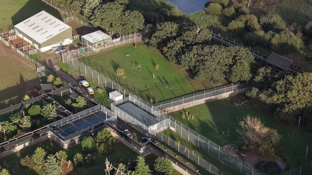 Aerial view of Yorkshire Wildlife Park with police and emergency vehicles gathered outside an enclosure.