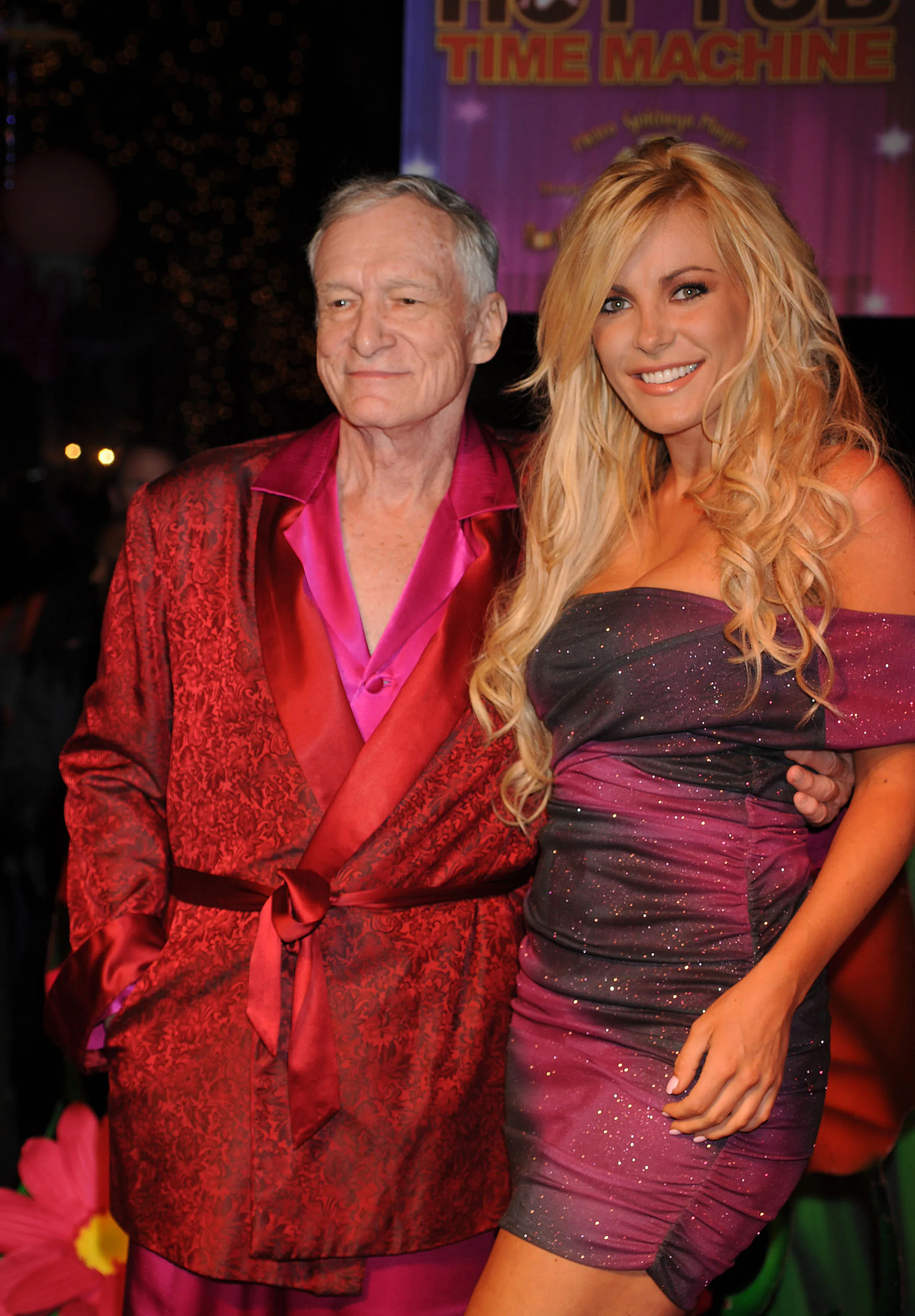Hugh Hefner and Crystal Harris posing together at an event.