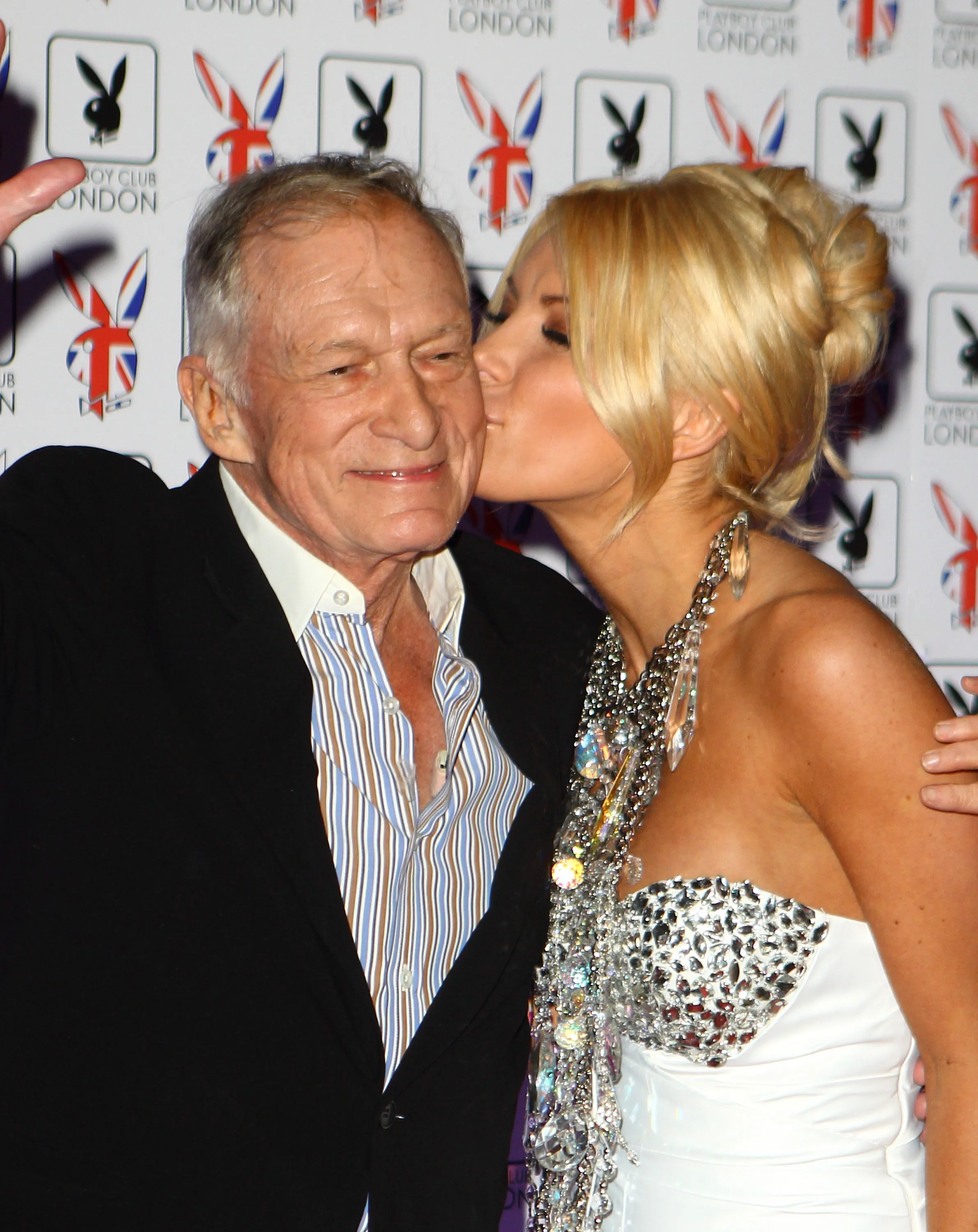 Crystal Harris kisses Hugh Hefner on the cheek at the opening of Playboy Club London.