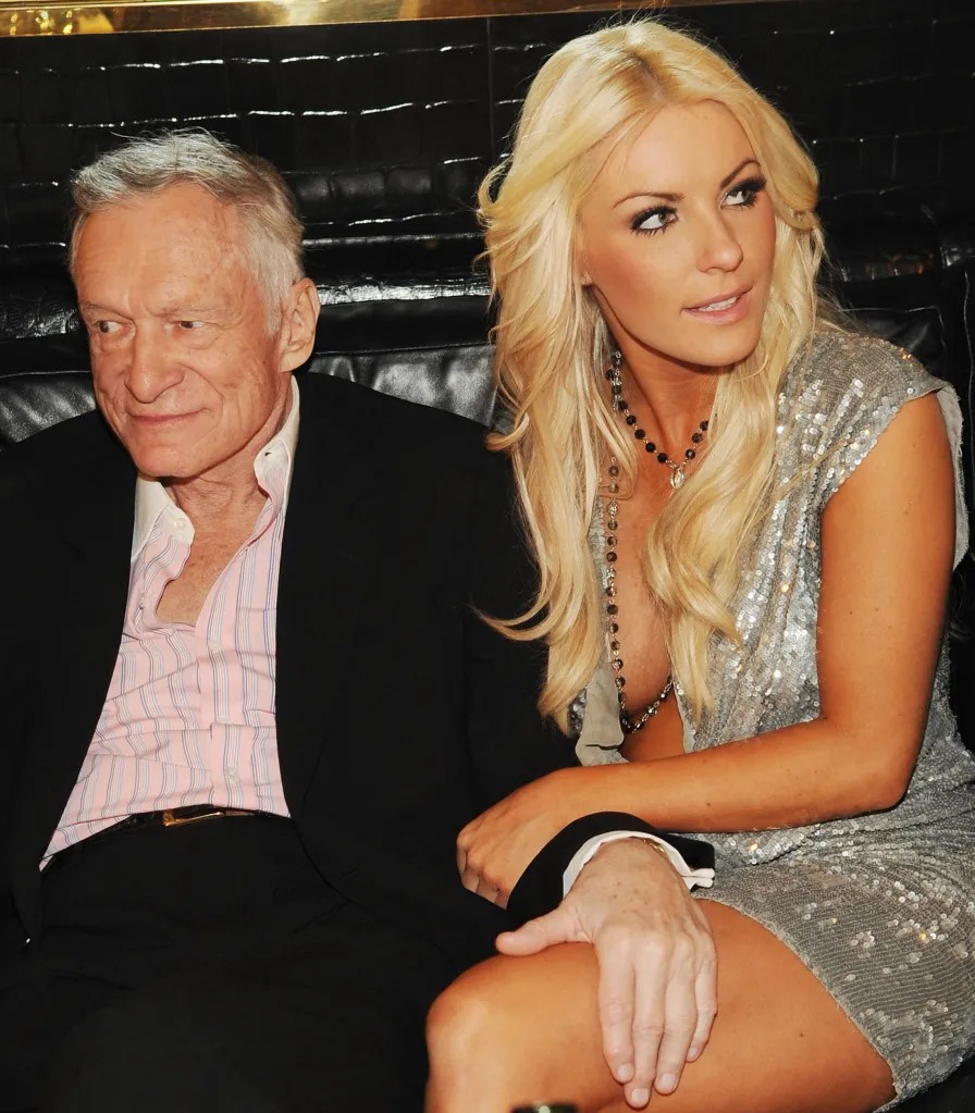Hugh Hefner and Crystal Harris sitting together on a couch.