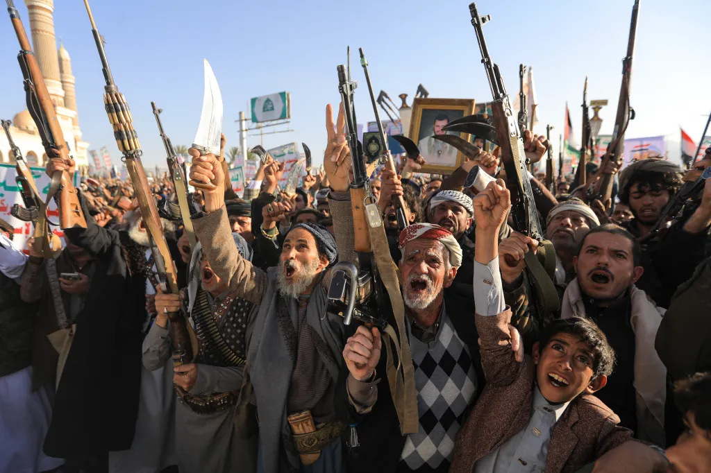 Huthi supporters brandish weapons during a demonstration marking Independence Day in Sanaa, Yemen.
