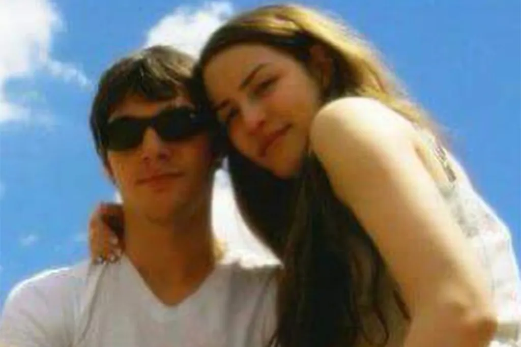 RJ Mitte and his former girlfriend Saint Sasha posing together outdoors against a blue sky.