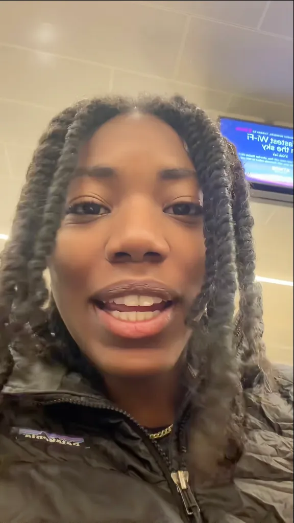 Santeon Brown recording a video at an airport.