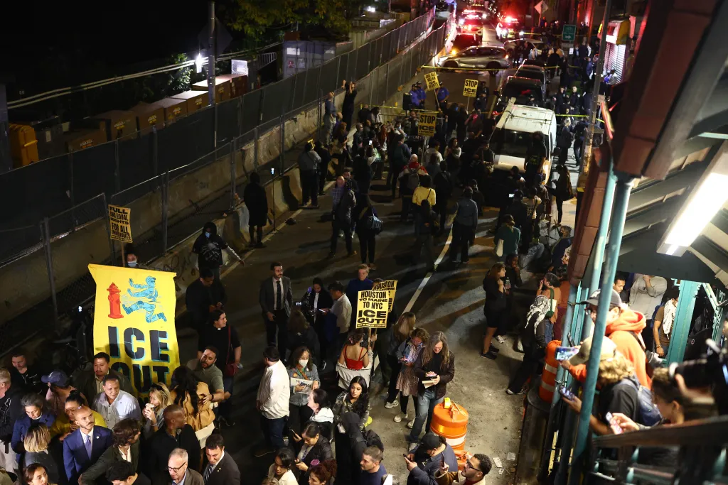 Protesters gather on a street near the scene where a man was shot by an ICE officer in the Bronx borough of New York.