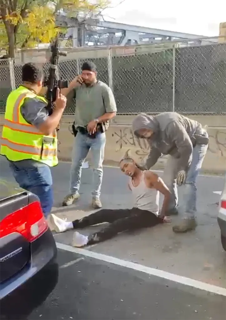 Federal agents stand near Oscar Belgal after he was shot during an encounter in the Marble Hill section of the Bronx, New York.
