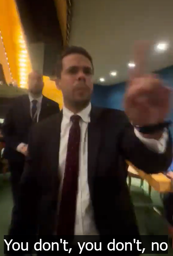 Richard Tur de la Concepcion in a suit wagging his finger while speaking.