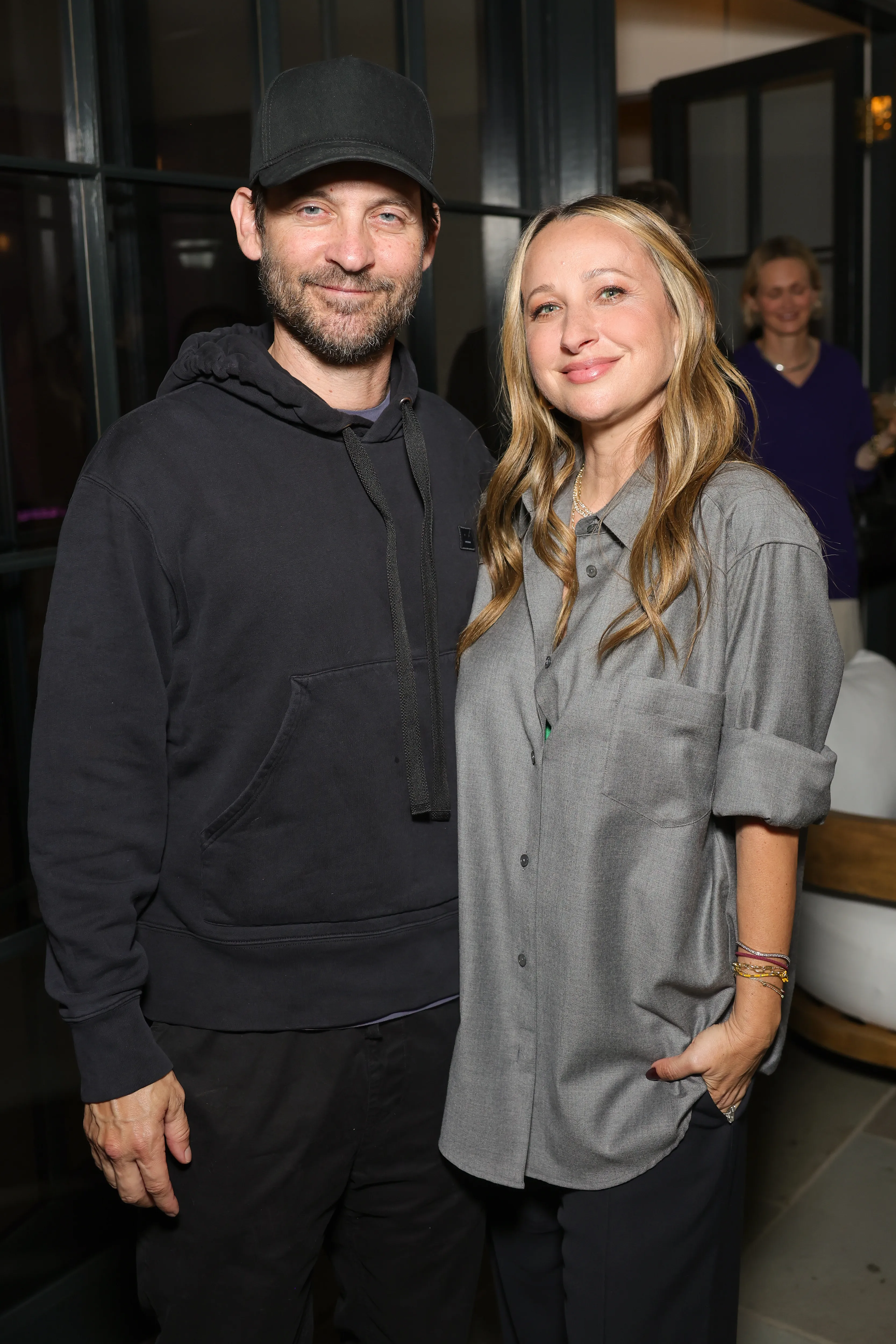 Tobey Maguire and Jennifer Meyer pose together at an event.