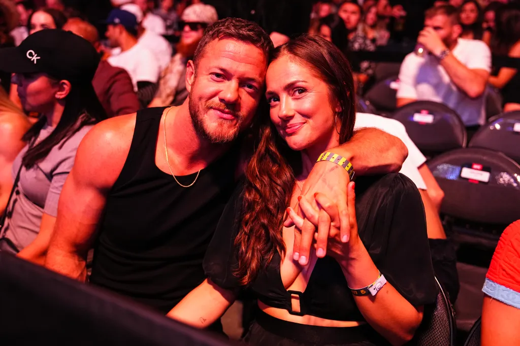 Imagine Dragons lead singer Dan Reynolds and actress Minka Kelly pose for a photo together.