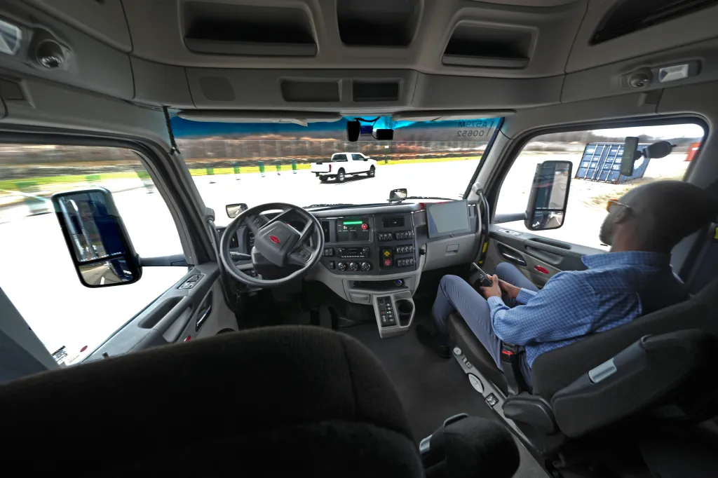 Interior view of a self-driving truck in motion.