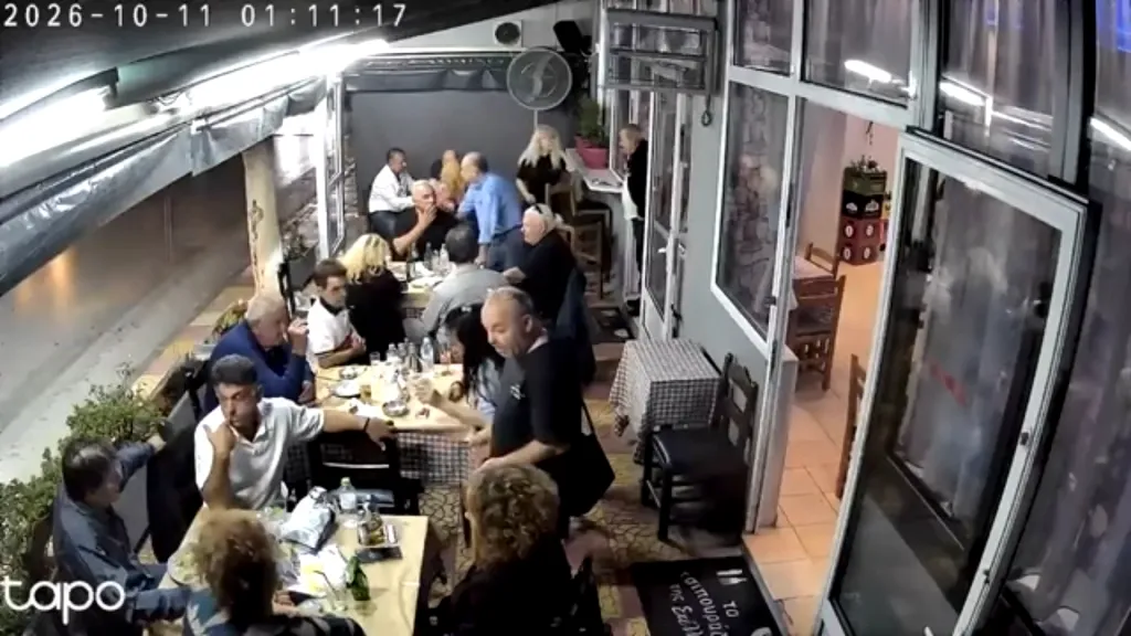 CCTV footage shows patrons dining at outdoor tables of a tavern moments before a car crashes into the seating area.