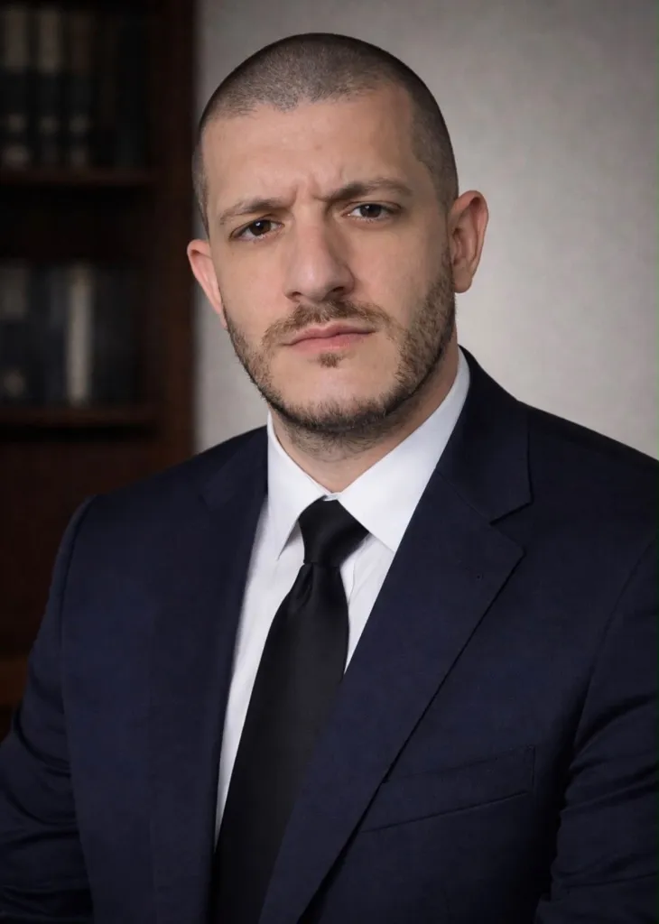 Israeli attorney Tai Sharki in a suit and tie.