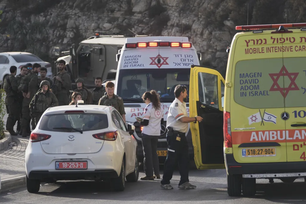 Israeli soldiers and emergency personnel gather near ambulances following a shooting attack.