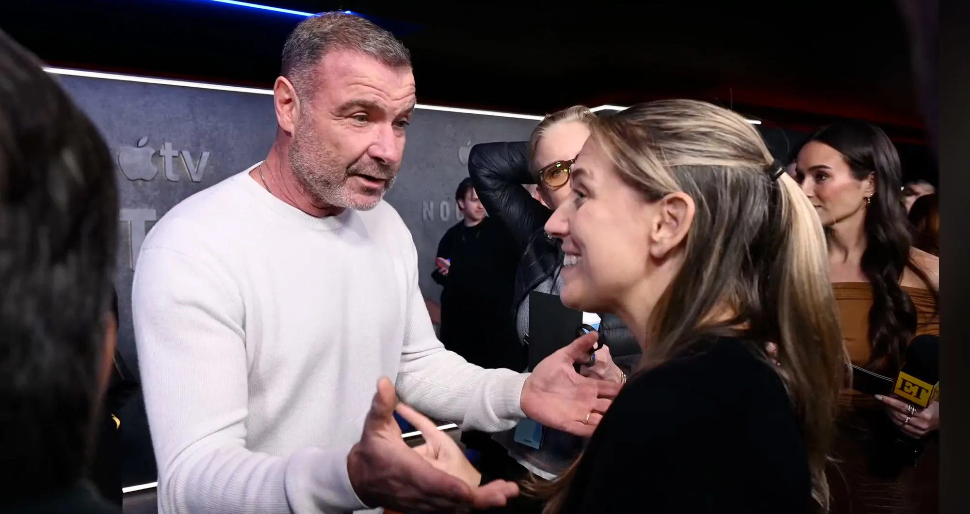 Liev Schreiber speaking in a heated exchange with a reporter.
