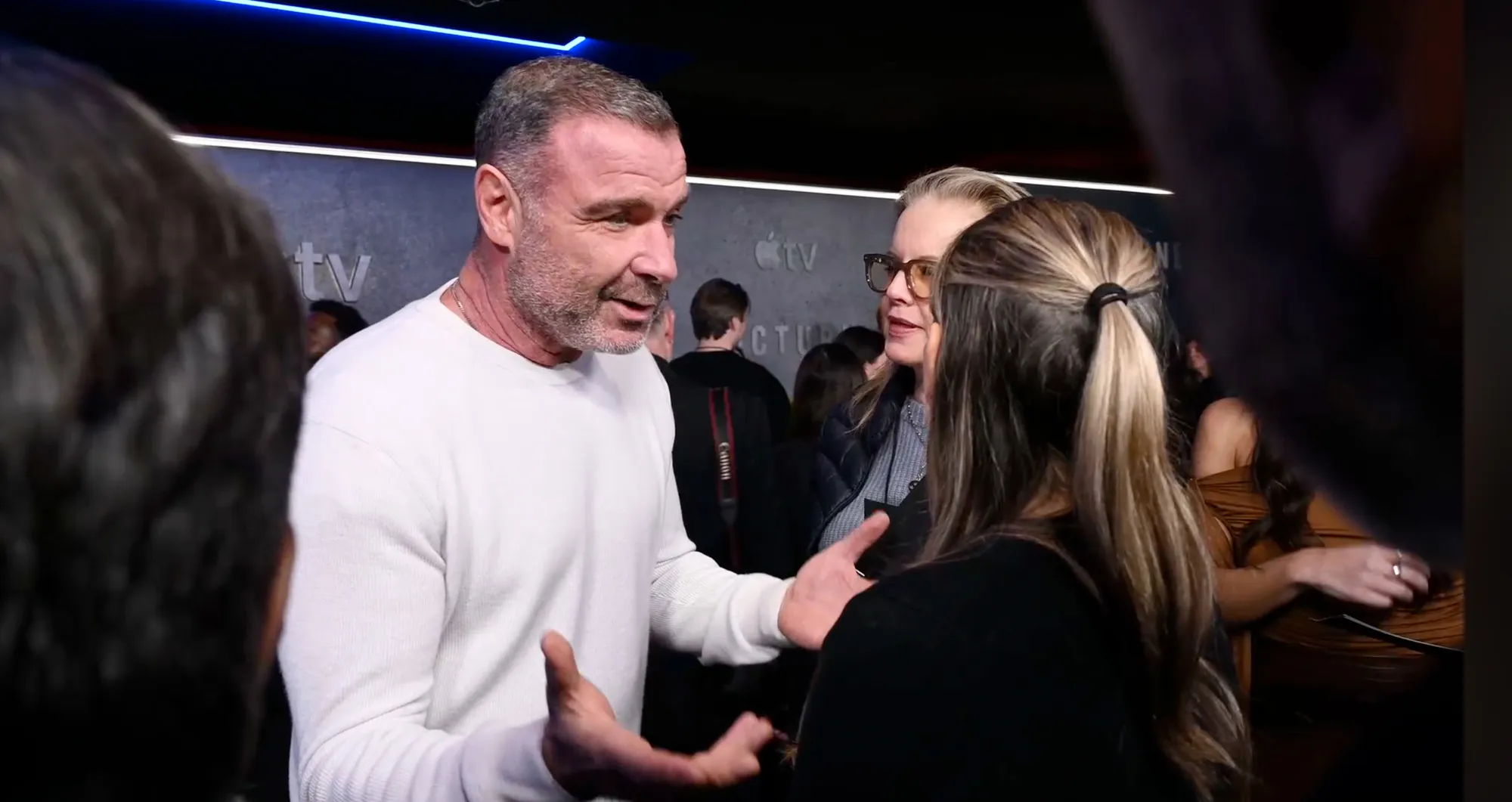 Liev Schreiber talking with a reporter at an event.