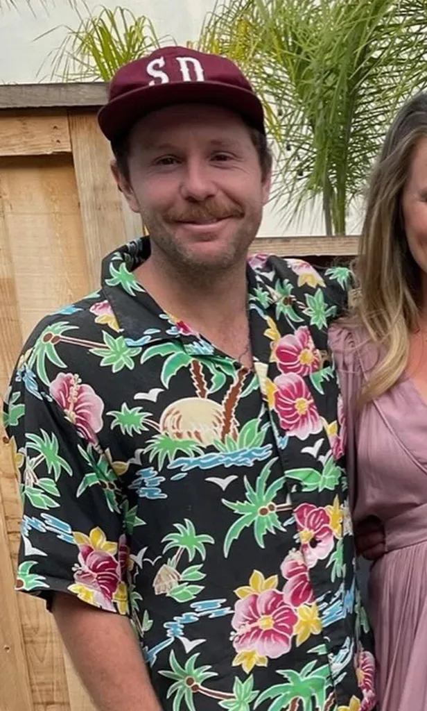 Jack Carter Rhoad wearing a maroon hat and a floral shirt.