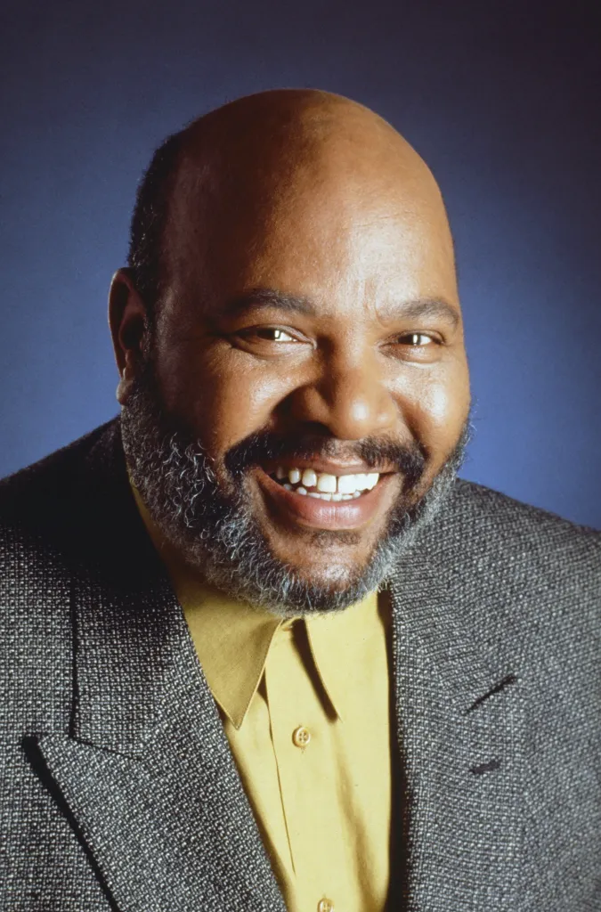 Portrait of James Avery as Philip Banks smiling.