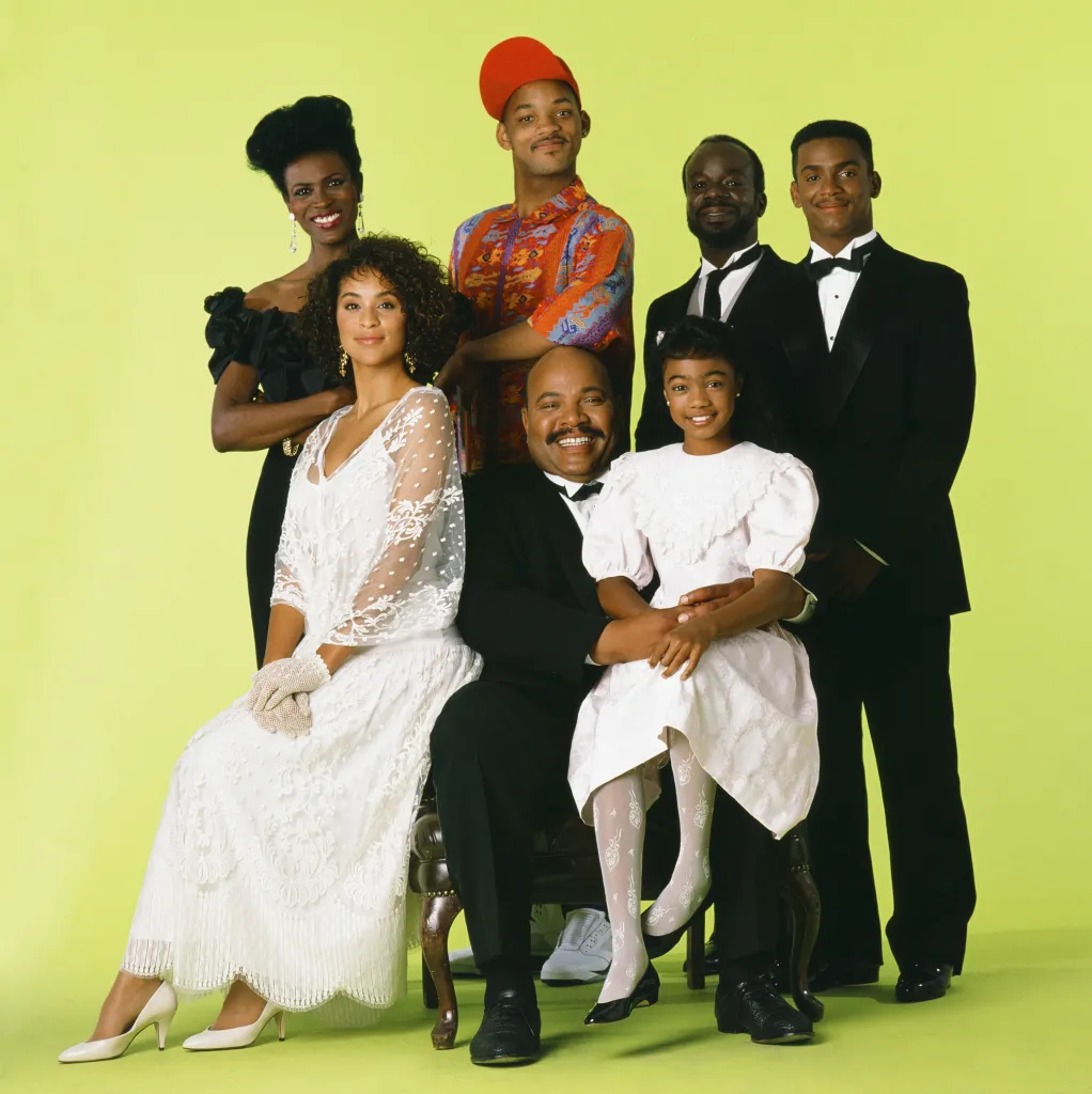 The cast of The Fresh Prince of Bel-Air pose together in a studio.