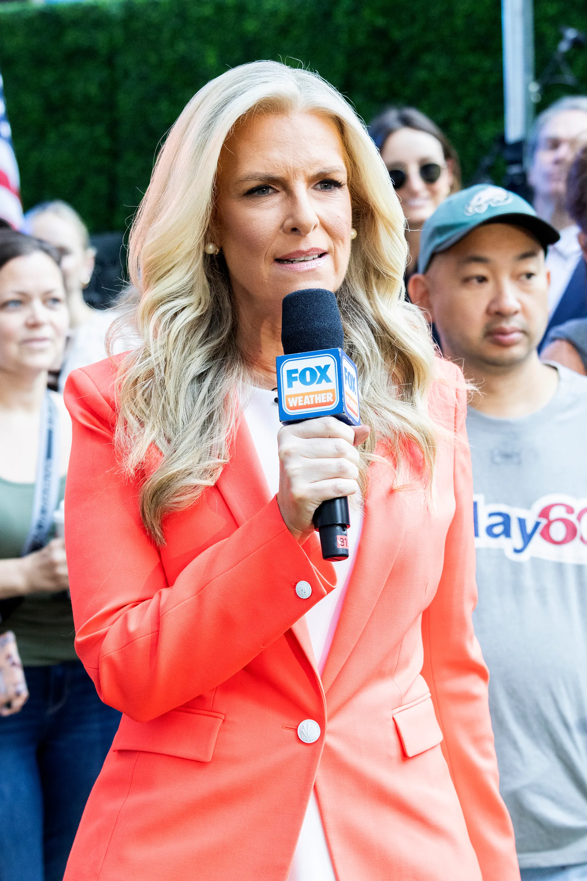 Janice Dean speaks into a Fox Weather microphone while giving a forecast.