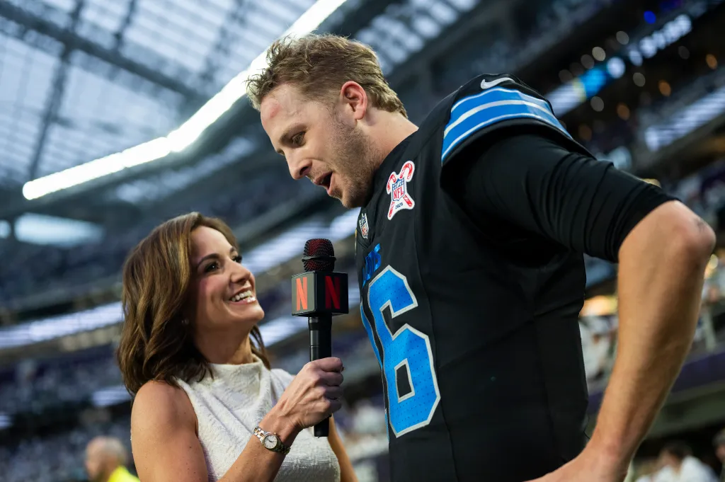 Jared Goff #16 of the Detroit Lions is interviewed by reporter Dianna Russini on the field before a game.