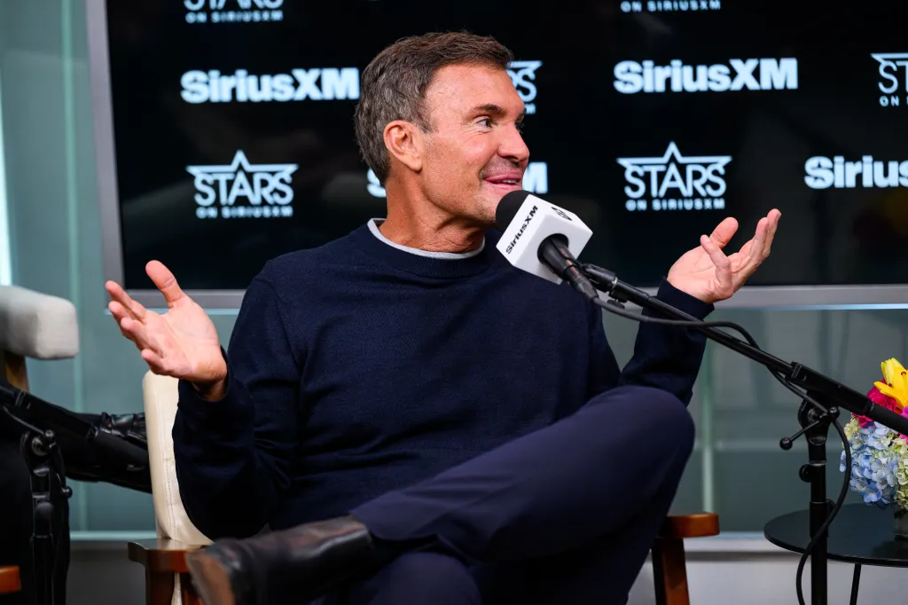 Jeff Lewis speaks into a microphone at SiriusXM Studios.