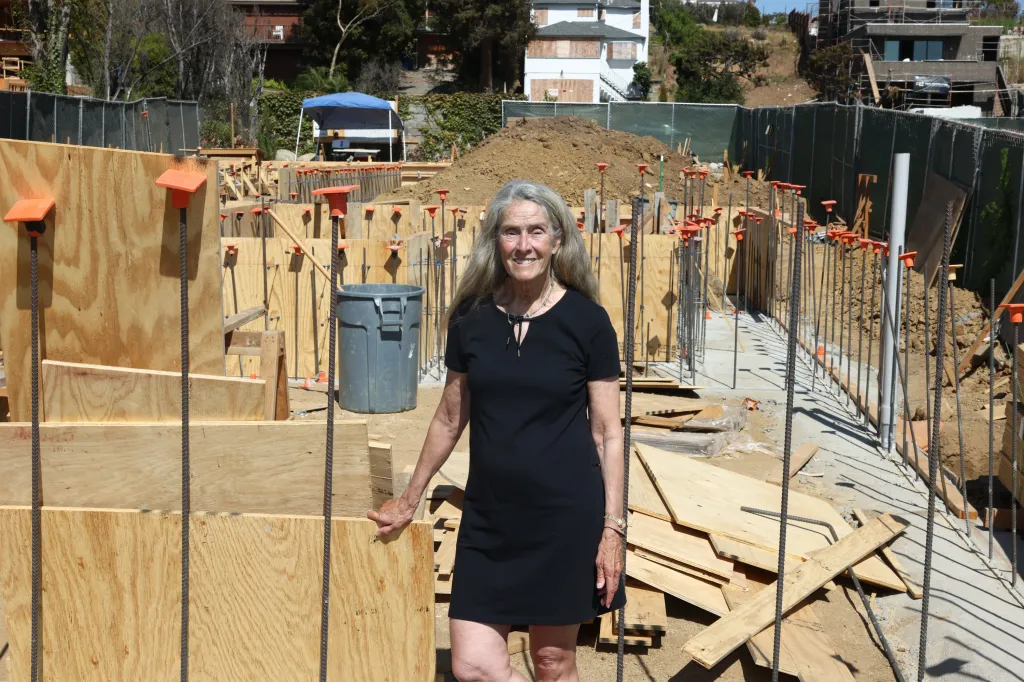 Sue Pascoe stands in front of her home under construction in Pacific Palisades, California.