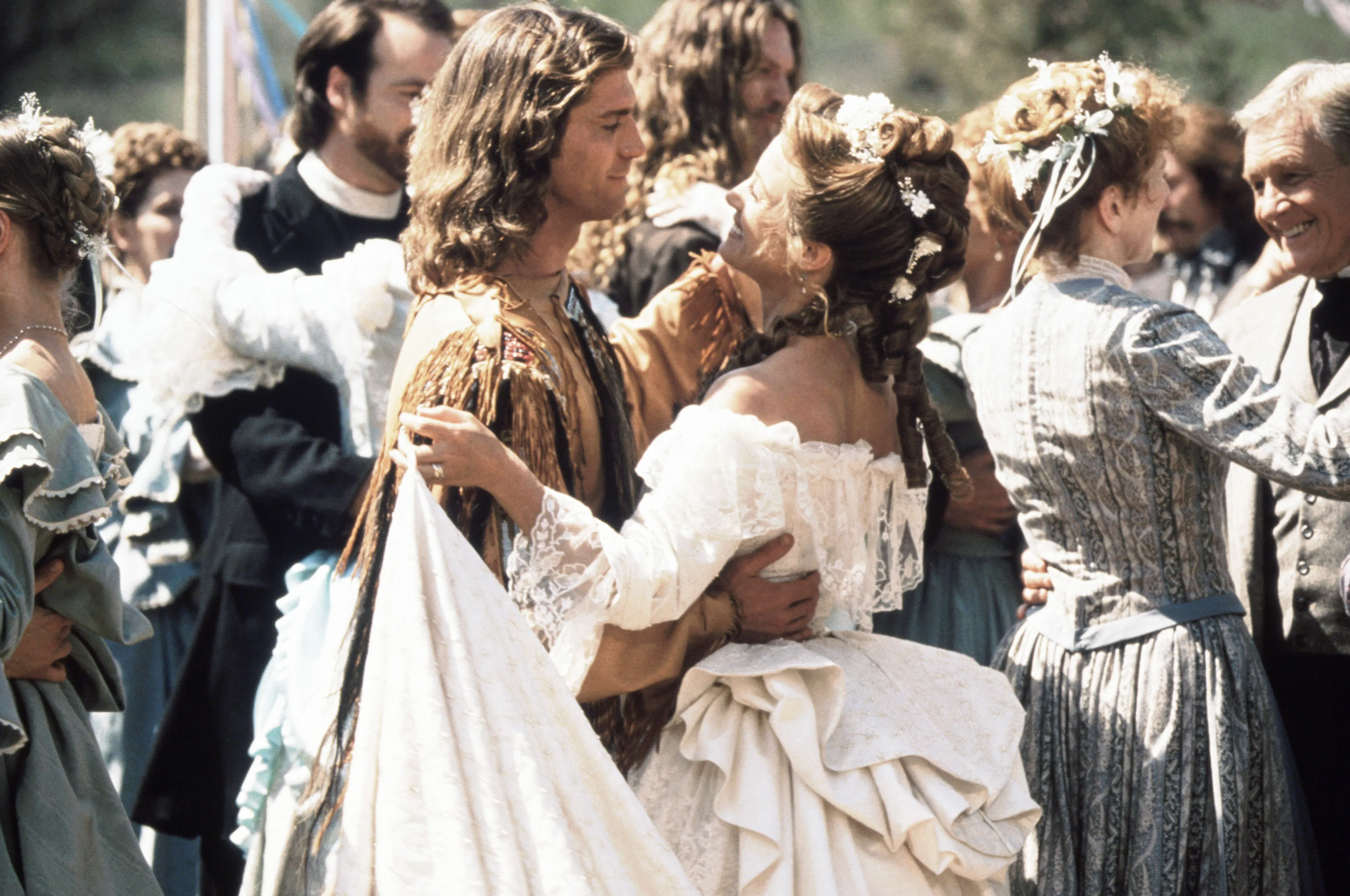 Joe Lando as Byron Sully and Jane Seymour as Dr. Michaela Quinn dancing in period clothing.