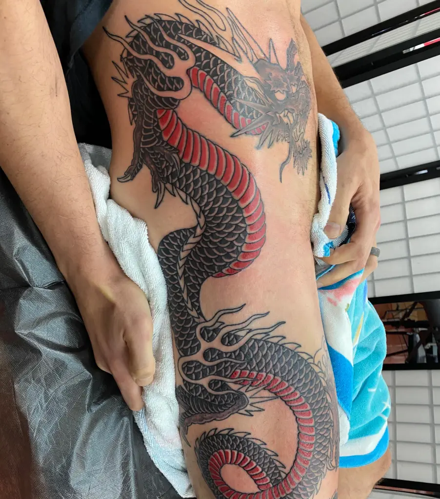 Joe Manganiello's large black and red dragon tattoo.