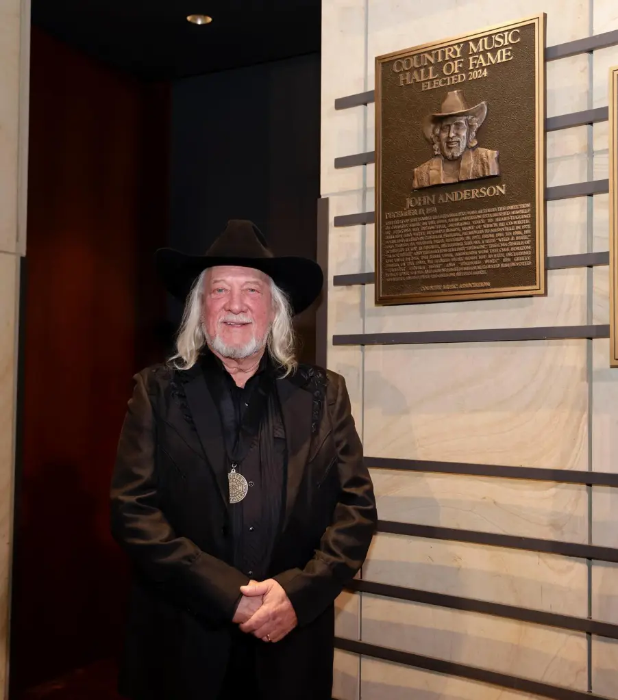 Country singer John Anderson stands next to his Country Music Hall of Fame plaque.
