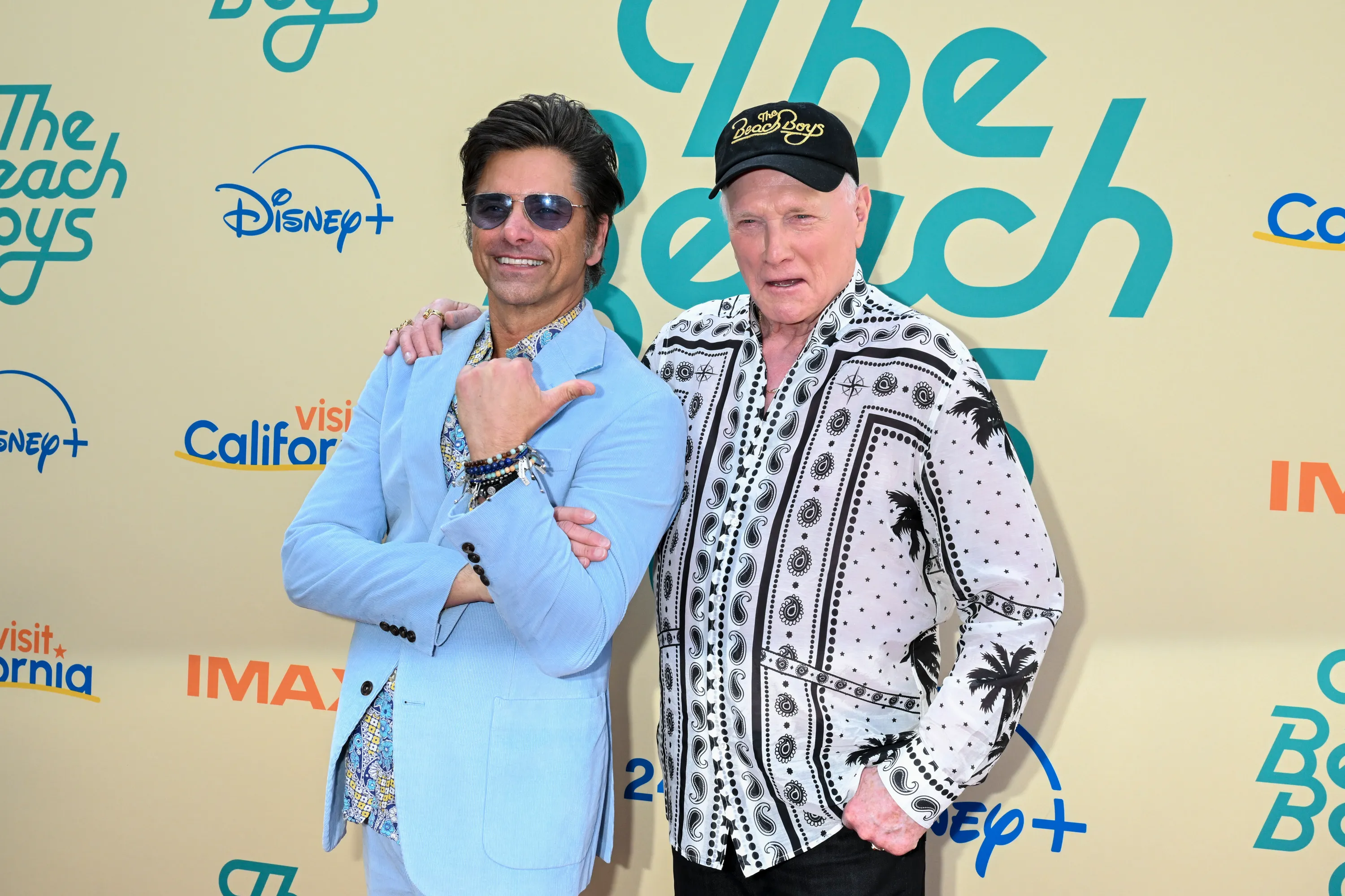John Stamos and Mike Love pose together at the premiere of